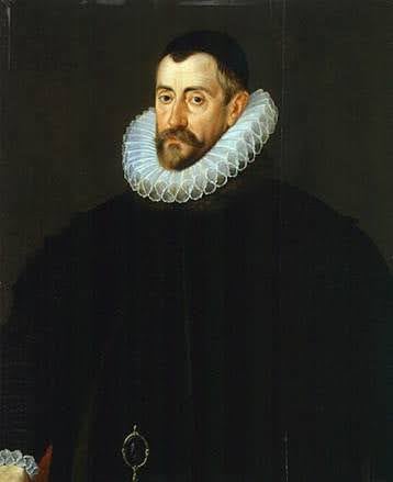 Portrait of a bearded man in a black outfit with a large white ruff collar, set against a dark background. His expression is serious and contemplative.