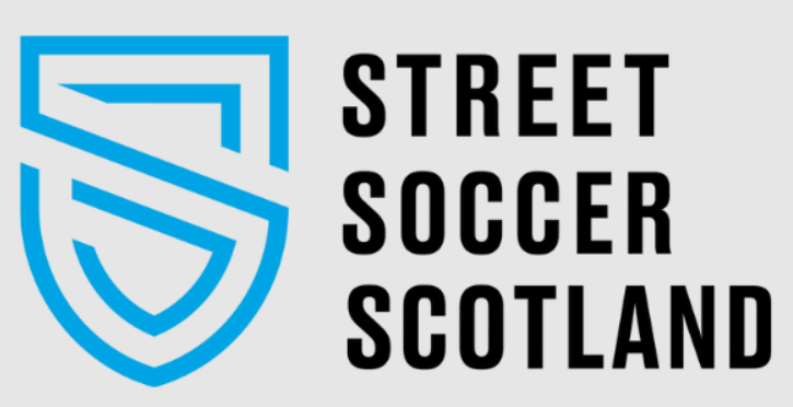 Blue shield logo with stylised "S" and "Street Soccer Scotland" text in bold black on a grey background.