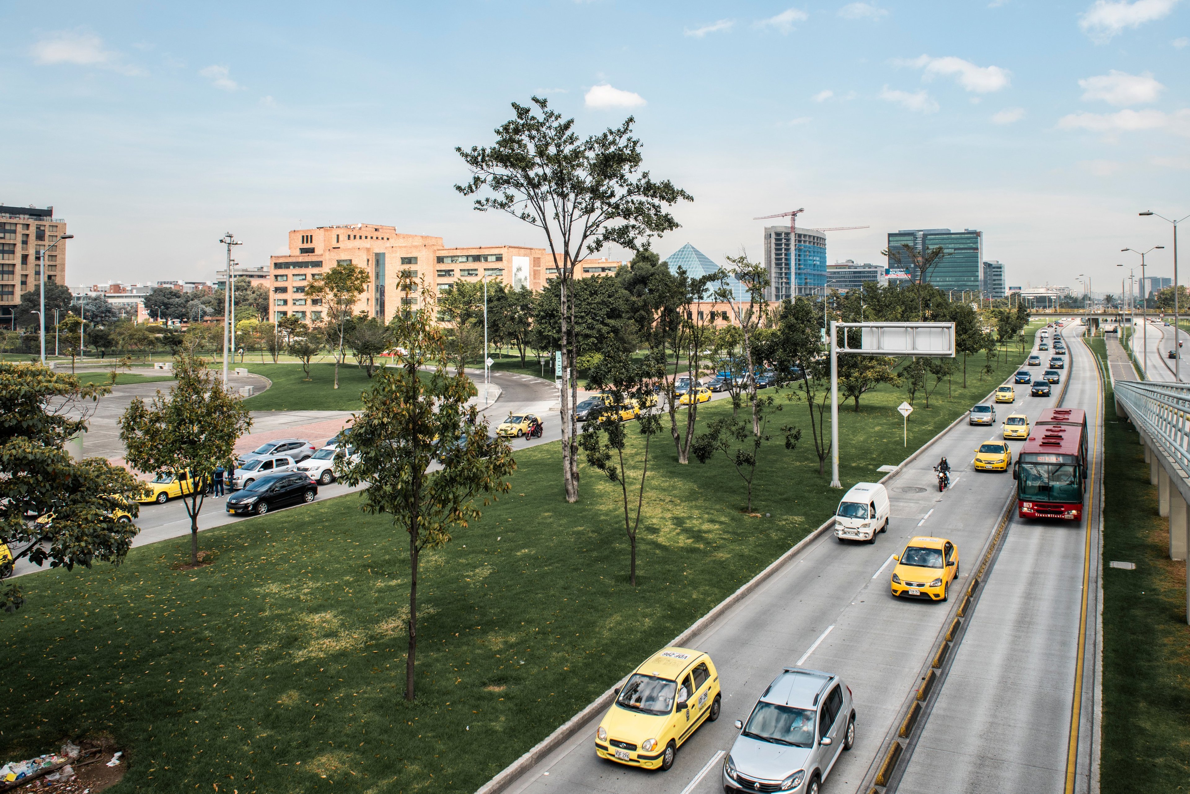 an image which shows a lot of traffic in Bogota City with tall buildings. This needs to be a photo rather than an illustration.

