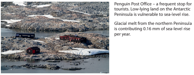 A rocky, snowy landscape with red buildings of the Penguin Post Office in Antarctica, highlighting sea-level rise issues mentioned in accompanying text.