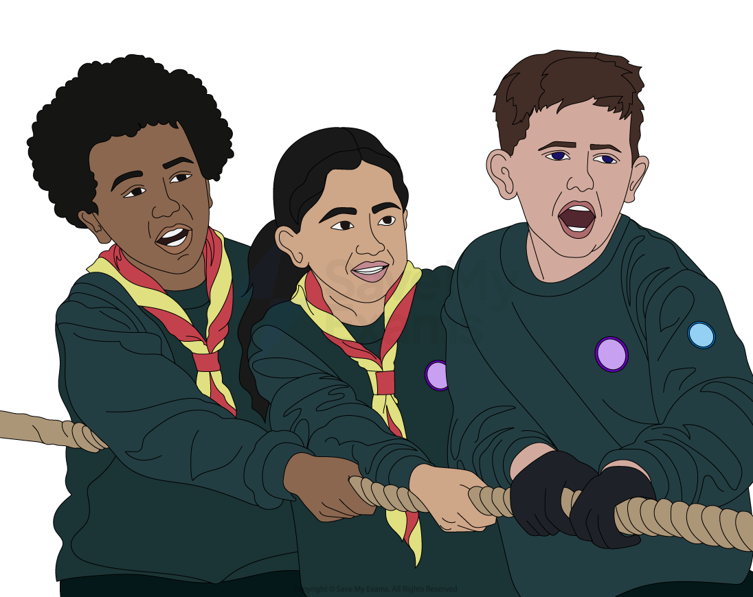 Three children in scout uniforms, wearing yellow and red neckerchiefs, are pulling a rope in a tug-of-war, showing determined expressions.