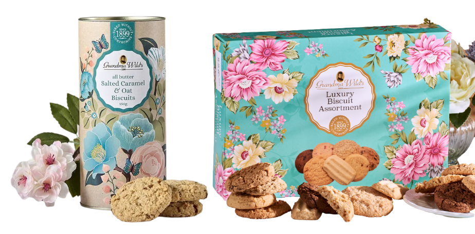 Decorative tins and boxes of Grandma Wild's biscuits with floral designs, featuring Salted Caramel & Oat Biscuits and a Luxury Biscuit Assortment.