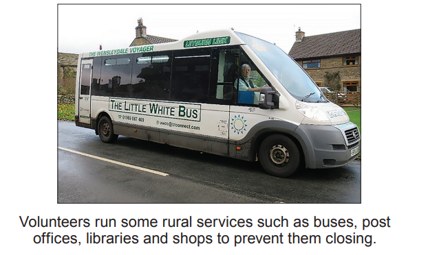 The Little White Bus parked on a rural road beside stone buildings, driven by a person, promoting community-run services in rural areas.