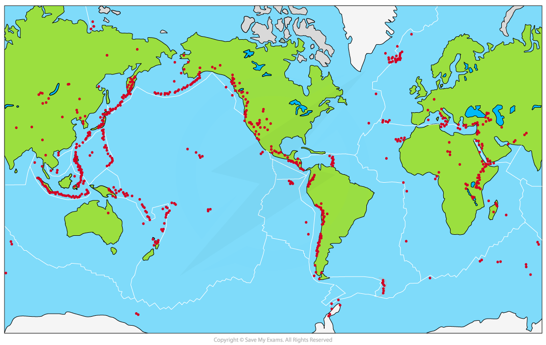 World map highlighting active volcanoes in red dots along tectonic plate boundaries, continents in green, oceans in blue, marked fault lines.