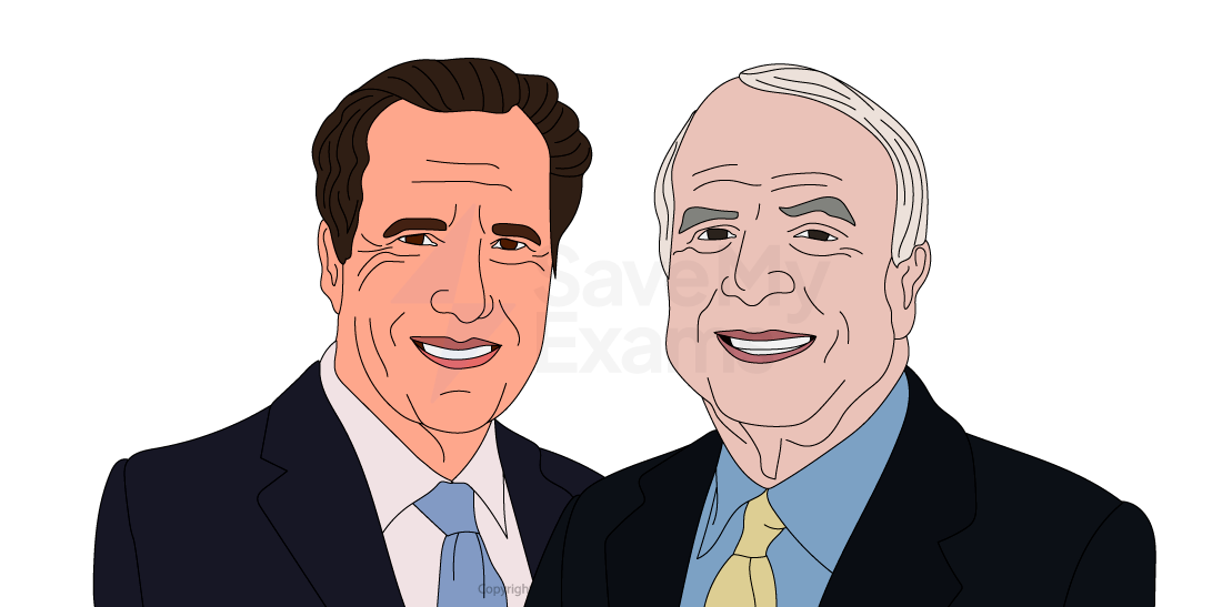 Two men in suits, one gesturing with hands outstretched, the other listening intently. Both appear engaged in a discussion or debate.