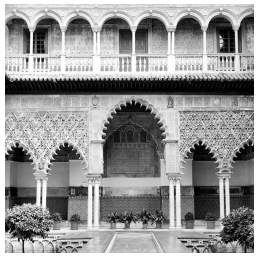 Historic Moorish courtyard featuring intricate arches and ornate carvings, surrounded by potted plants and set against a tiled wall background.
