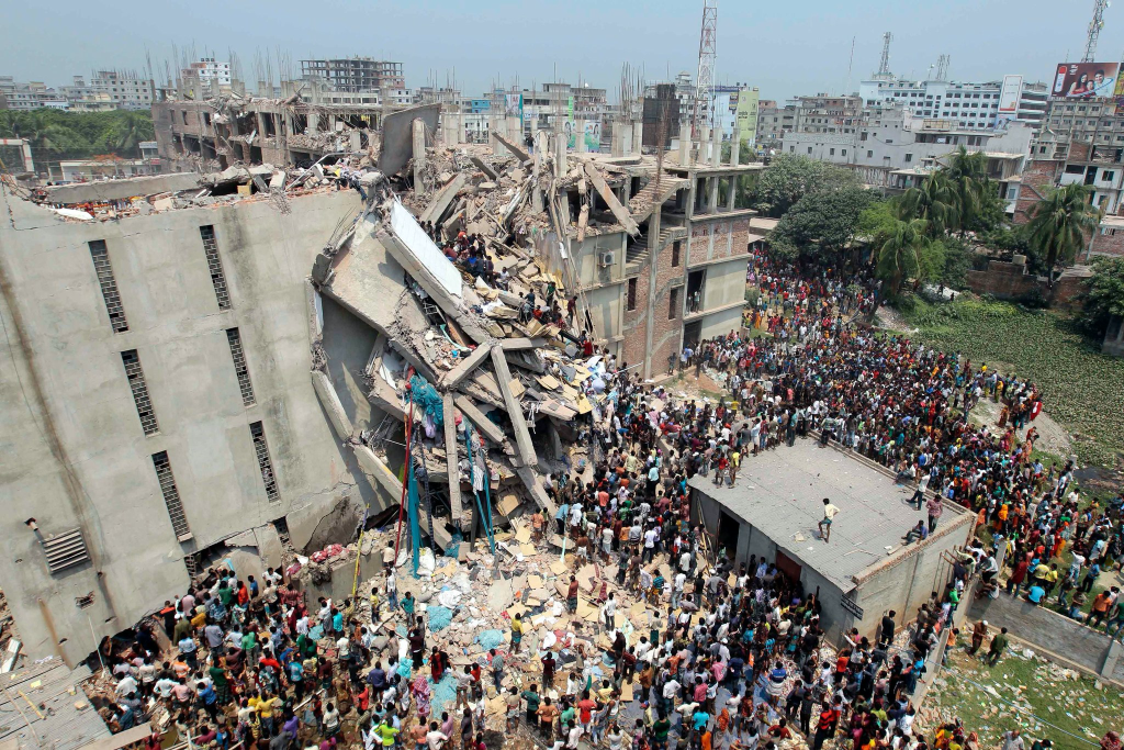 A collapsed building in an urban area, surrounded by rescue workers and observers