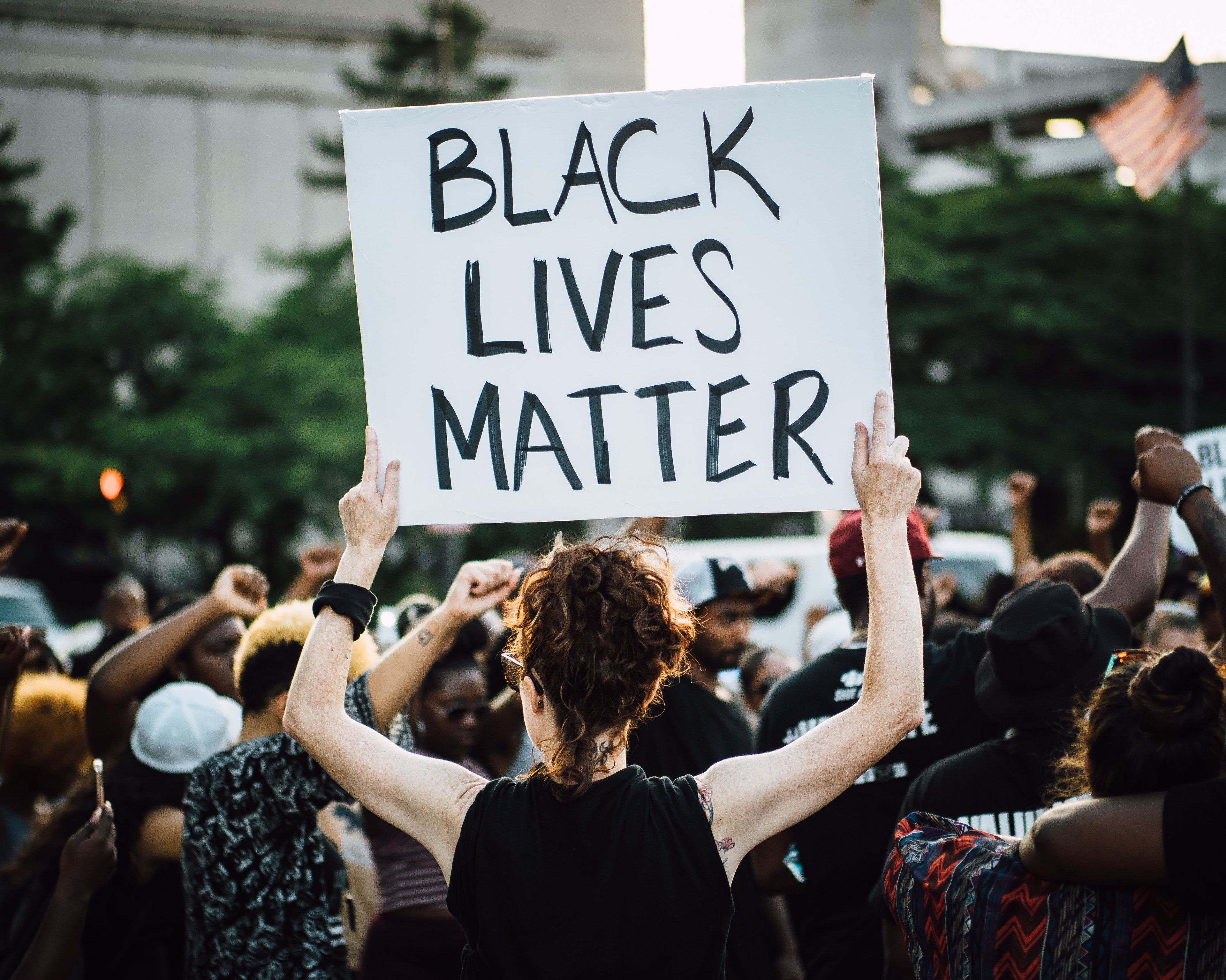 A Black Lives Matter march in Minneapolis, with a protestor holding a placard within a crowd