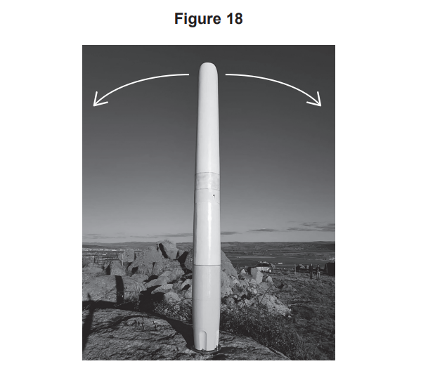 Tall, cylindrical antenna on rocky ground beneath open sky, with two curved arrows above it indicating side-to-side rotational movement