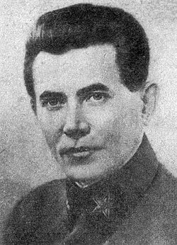 Black-and-white portrait of a stern middle-aged man in a high-collared military-style uniform, facing the camera against a plain background