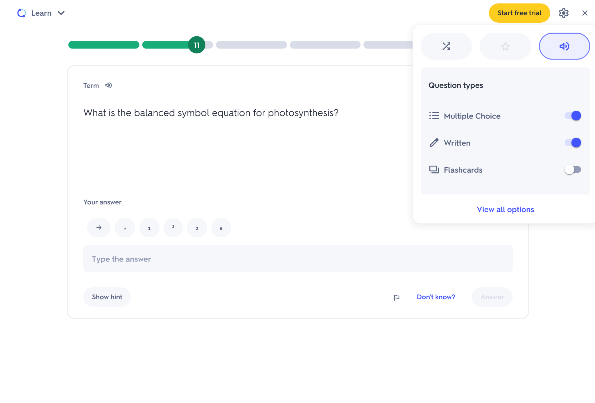 Online learning screen asking “What is the balanced symbol equation for photosynthesis?” with text answer box and options for multiple choice, written and flashcards