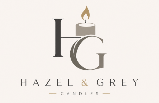 Hazel & Grey Candles logo with large stylised H and G, a lit candle forming part of the design, in neutral grey and gold tones on a light background