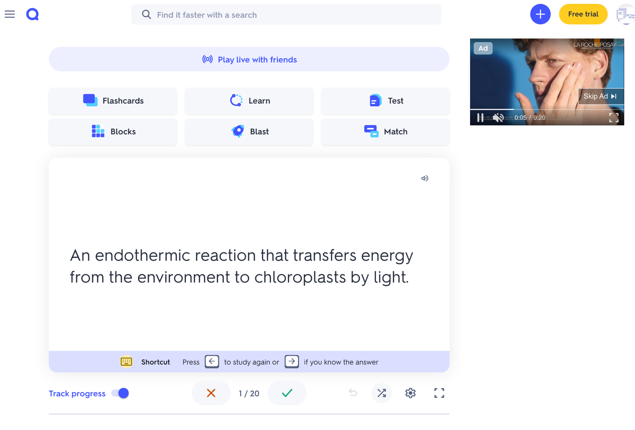 Quizlet-style revision screen showing a flashcard with the definition of photosynthesis and navigation controls below, plus an advert video on the right.