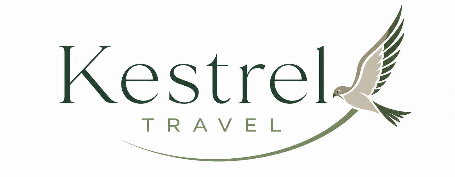 Kestrel Travel logo with elegant green serif text and a stylised flying kestrel swooping beneath, forming a curved line under the word “Travel”