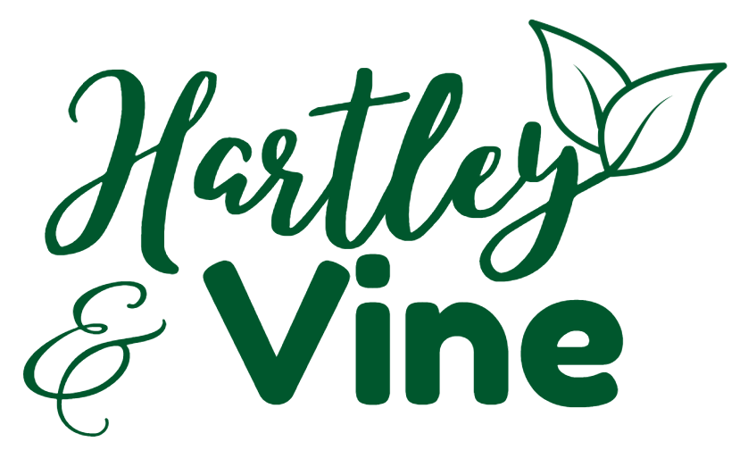 Hartley & Vine logo in dark green script and bold text, with two outlined leaves sprouting from the letter Y on a white background