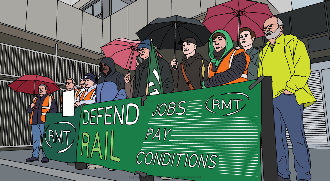 Rail workers stand in the rain behind an RMT banner reading “Defend Rail, Jobs, Pay, Conditions” during an official picket demonstration