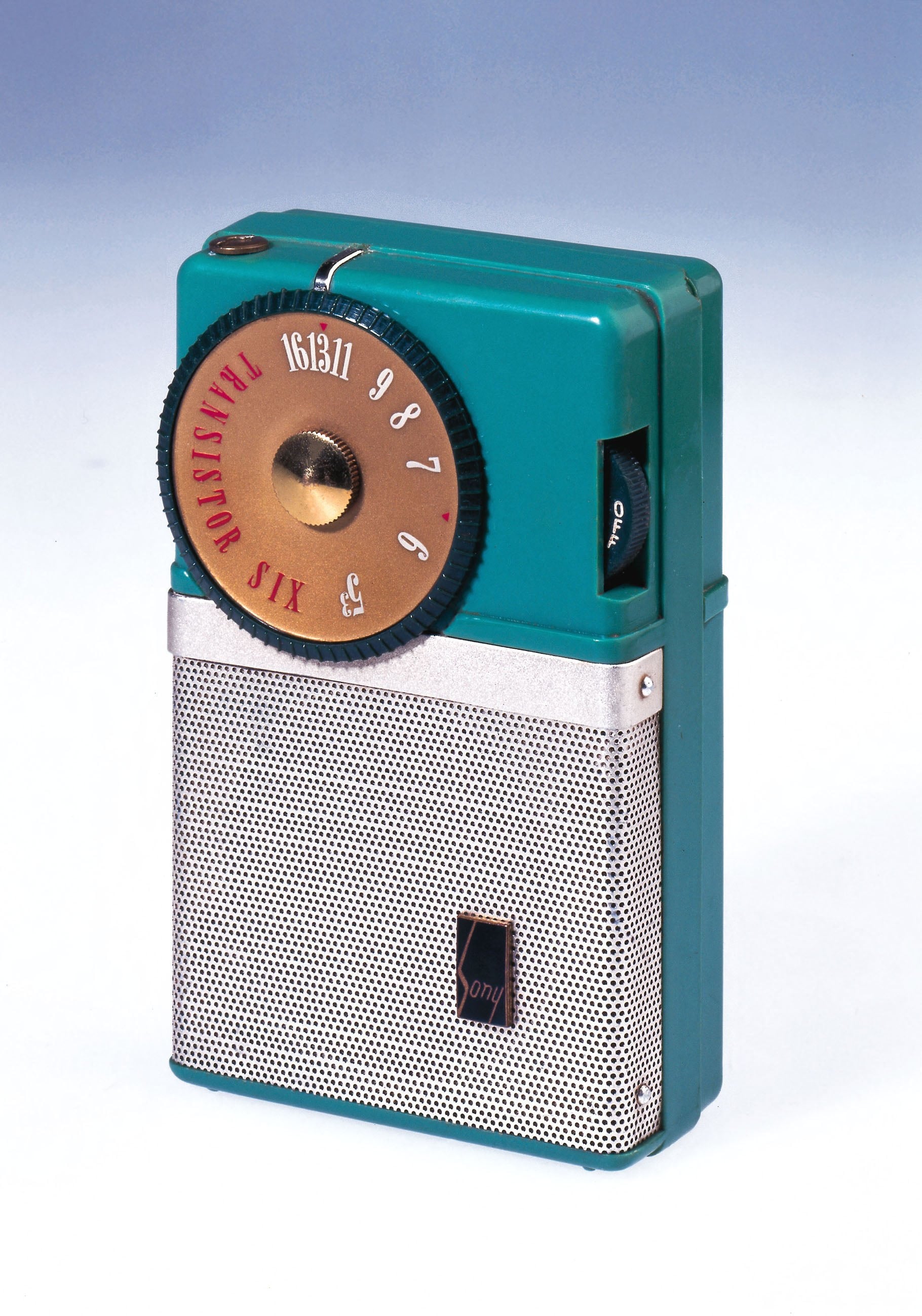 Vintage cream-coloured portable transistor radio with a red circular tuning dial and silver speaker grille, standing upright against a plain gradient background