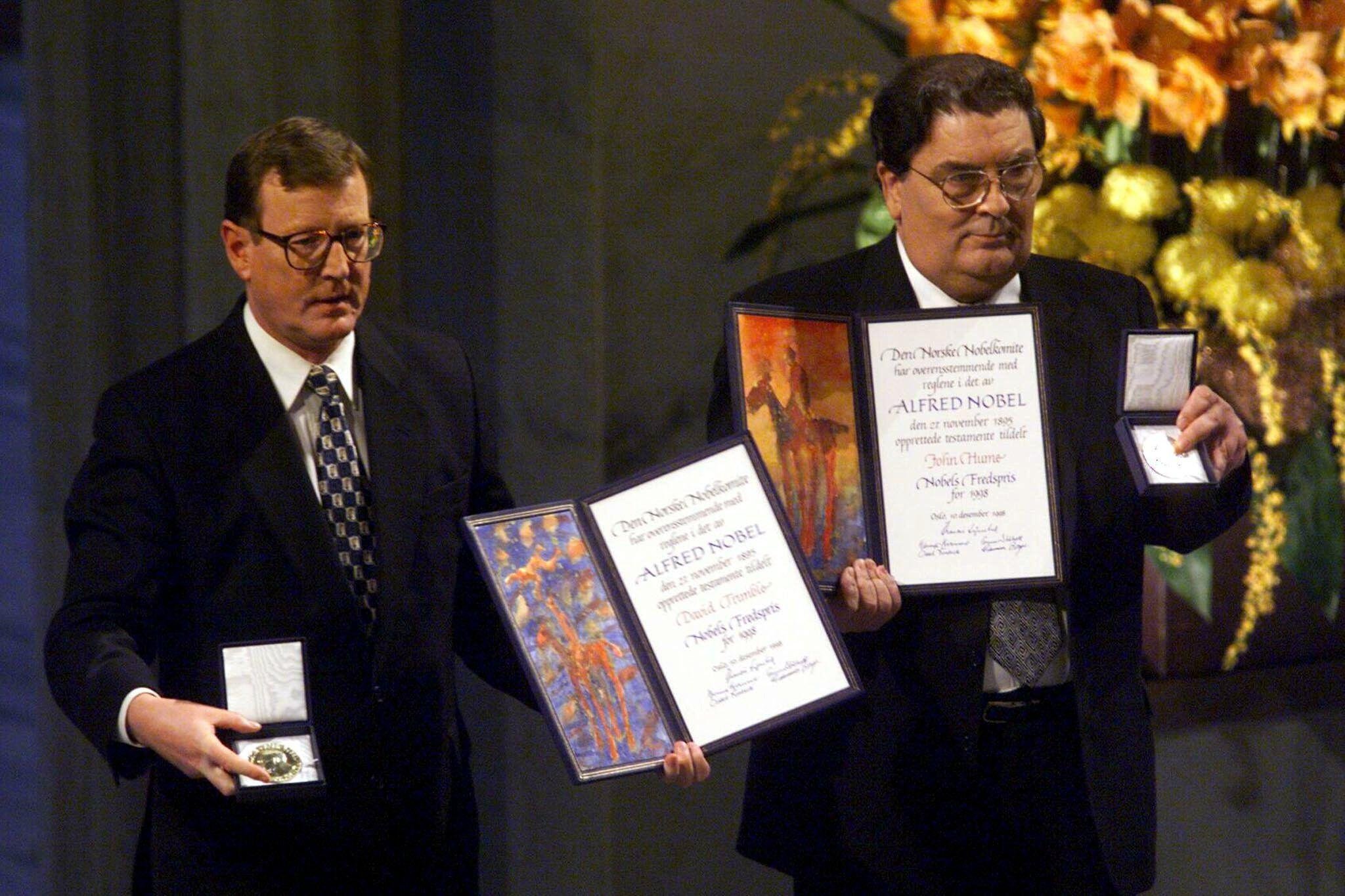 John Hume and David Trimble receive their 1998 Nobel Peace Prize medals and certificates, recognising their roles in negotiating the Good Friday Agreement.